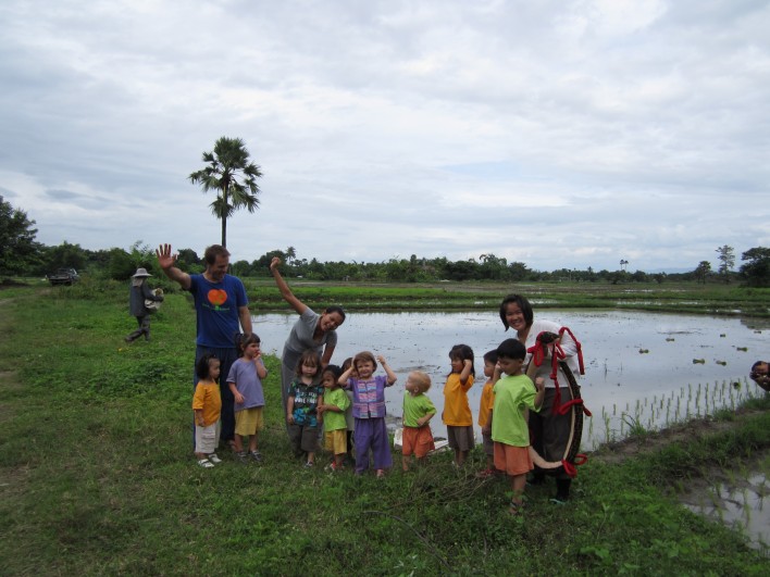 Panyaden School's bilingual students waving goodbye at rice field