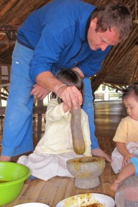 IMG_0990 Teacher helping child to pound tumeric for Cotton Project at Panyaden