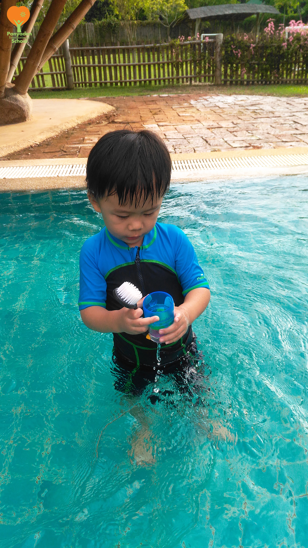 Panyaden swimming club after school - young student playing with the water