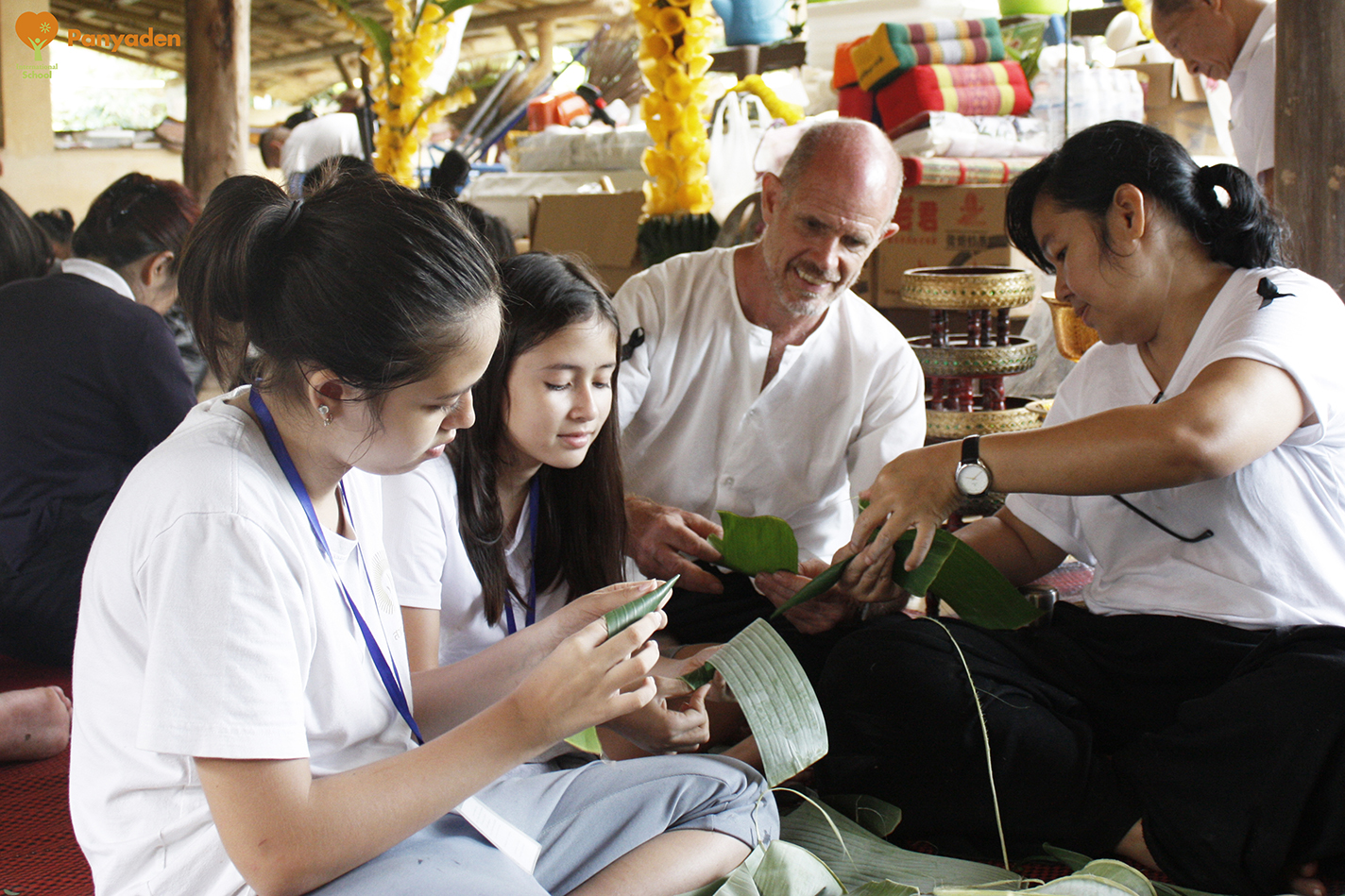 Panyaden students and parents making banana leaf receptables for offerings Jula Khatina in CHiang Rai Panyaden students and parents making banana leaf receptables for offerings Jula Khatina in CHiang Rai